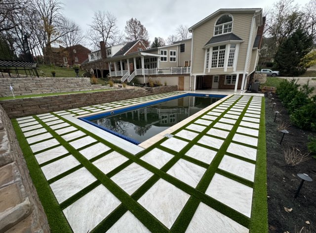 Pool with pavers and grass Photo